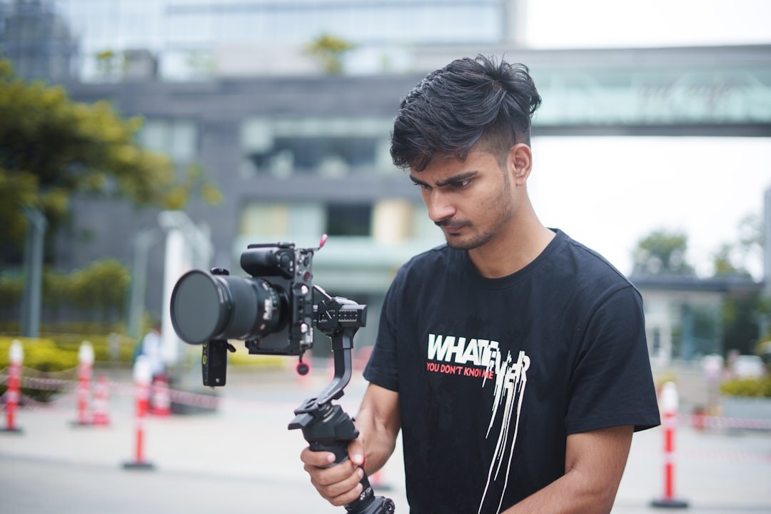 Journalist filming breaking news on location outdoors with professional camera