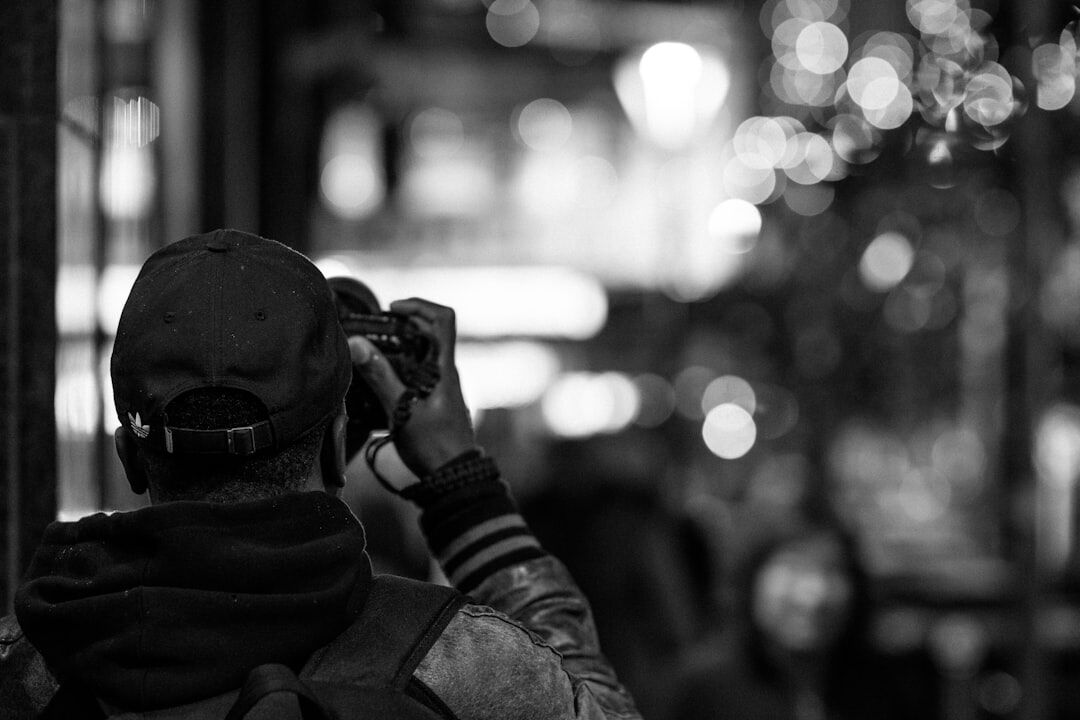 Photojournalist capturing impactful news images outdoors on the street